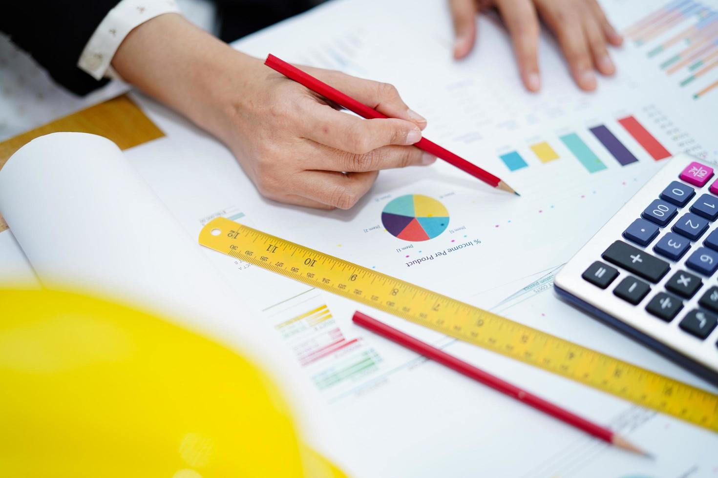 Asian accountant working and analyzing financial graph reports photo