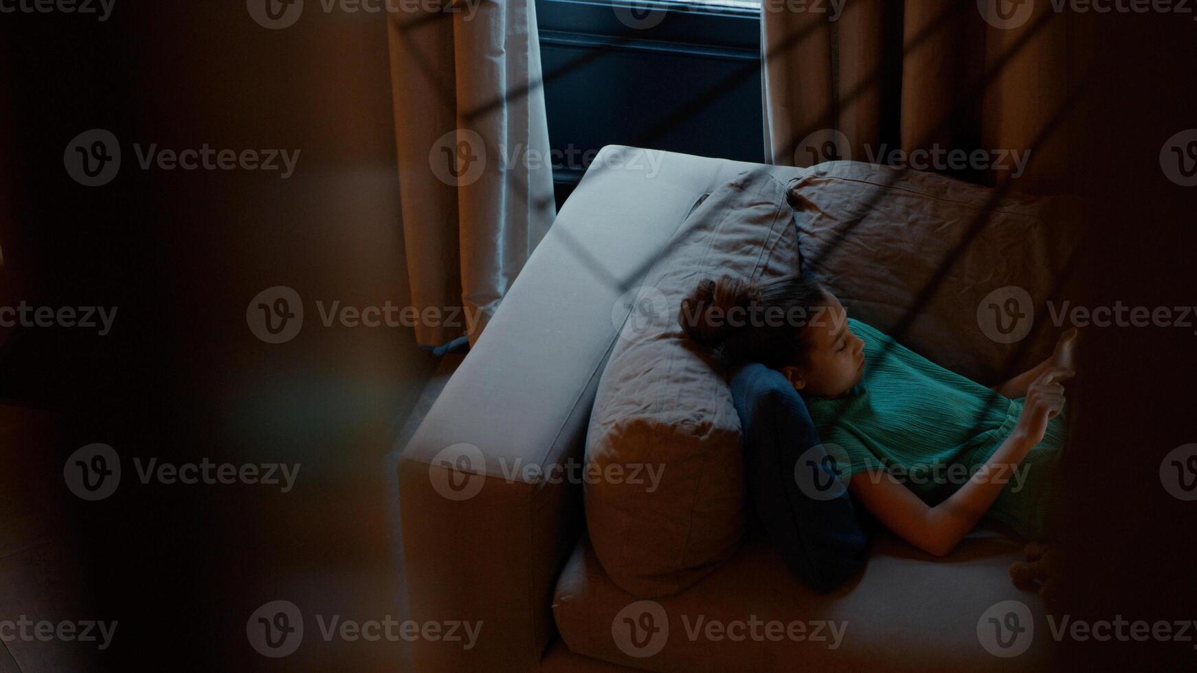 Girl lying on couch using tablet photo