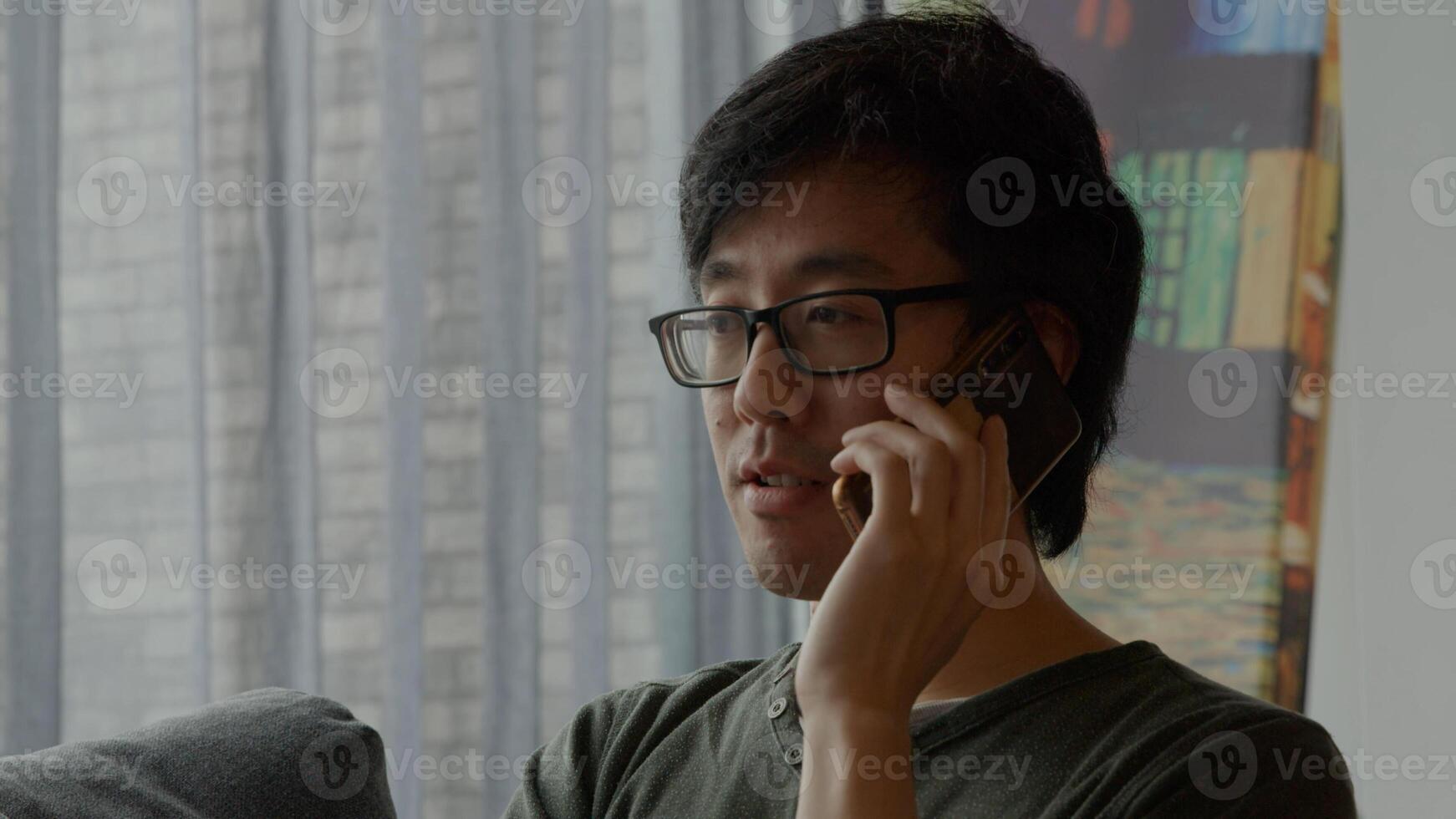 Man in living room calls with mobile phone photo