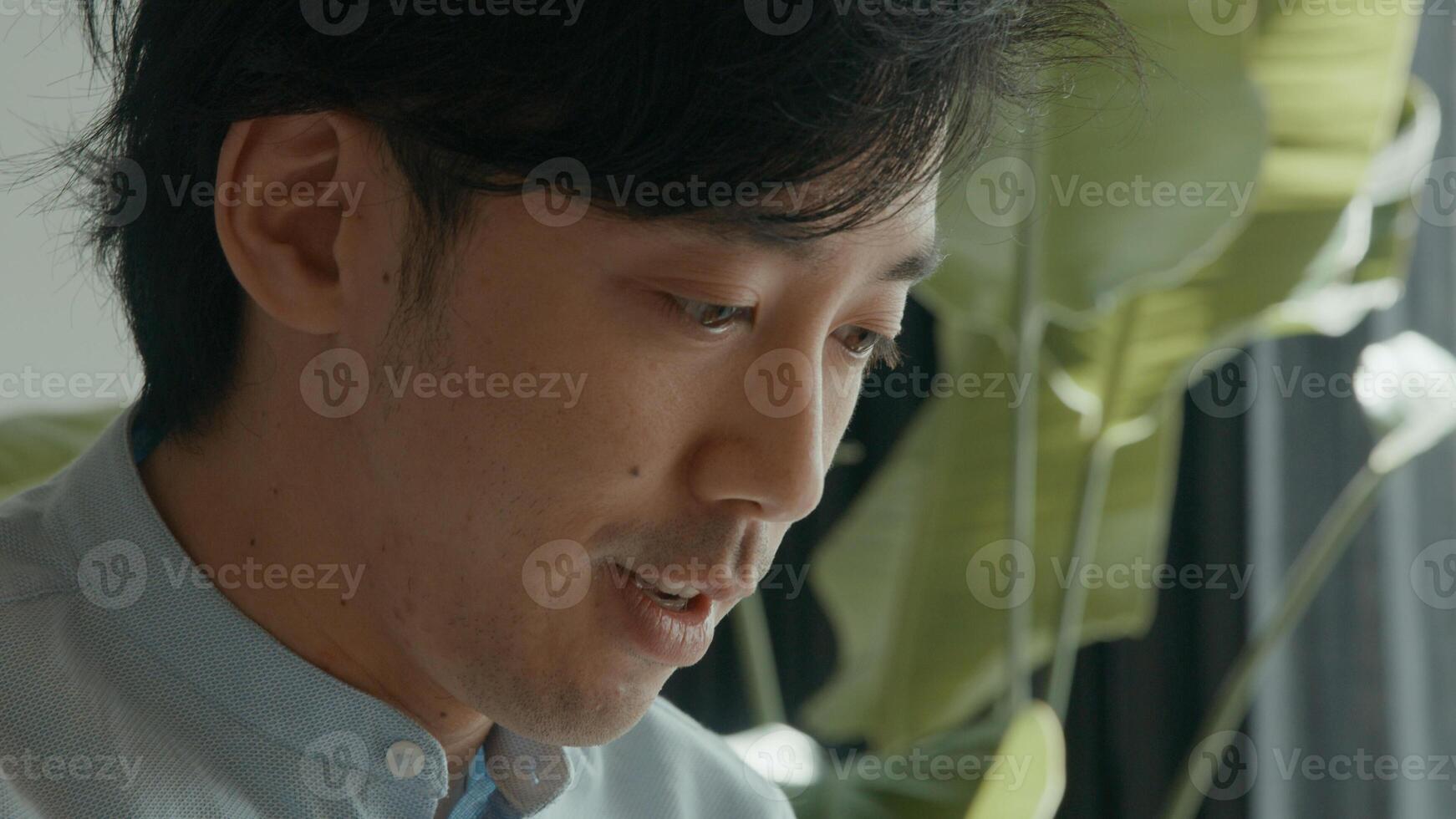 Man talks whilst watching screen laptop photo