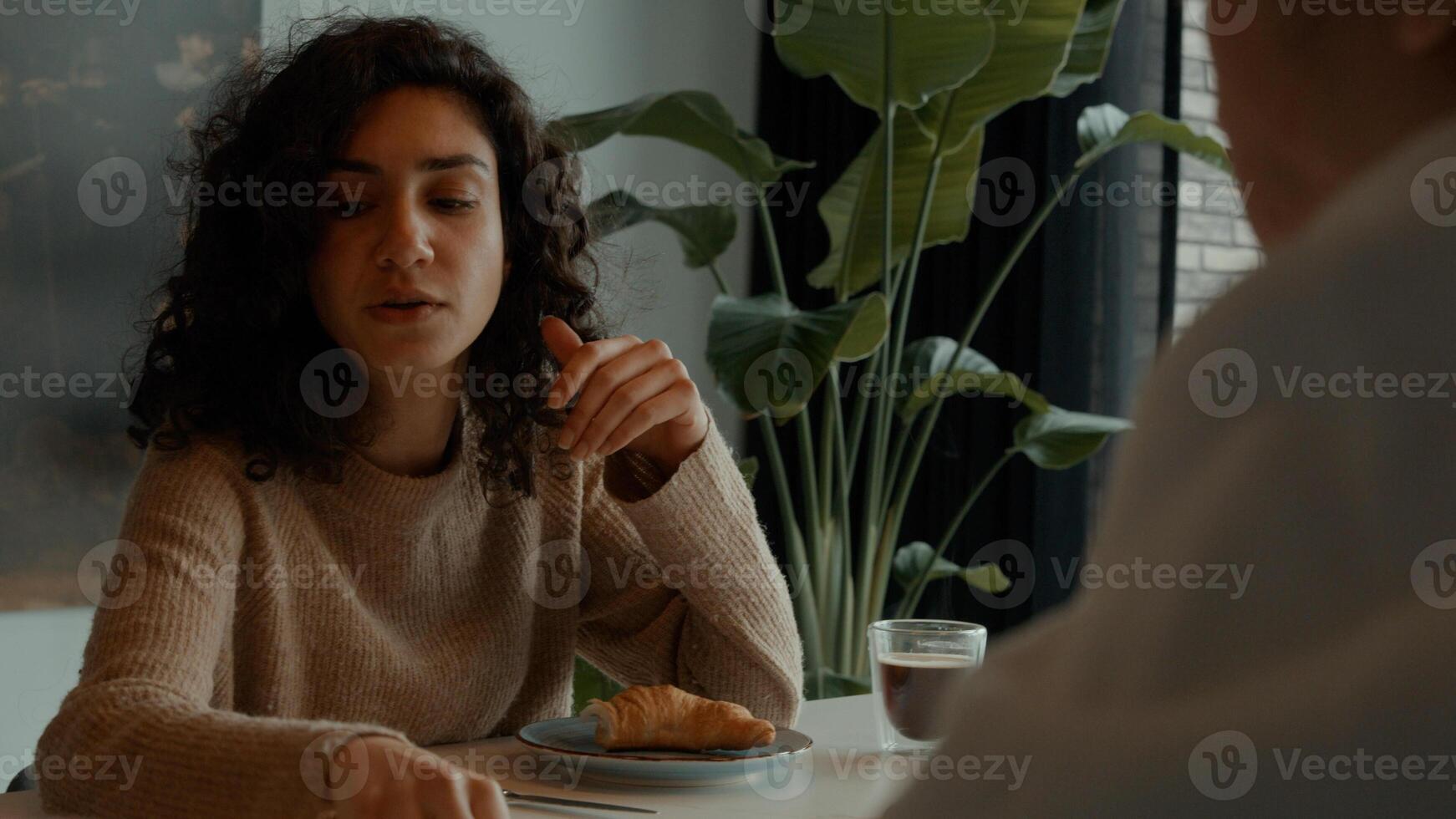 Woman talks to man at breakfast table photo