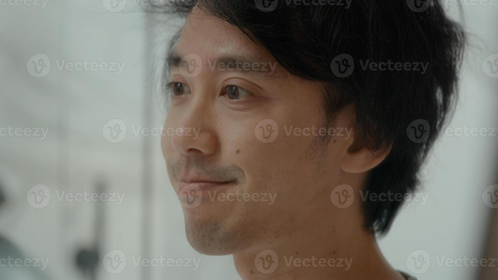 Man in bathroom wipes face and makes funny faces in mirror photo