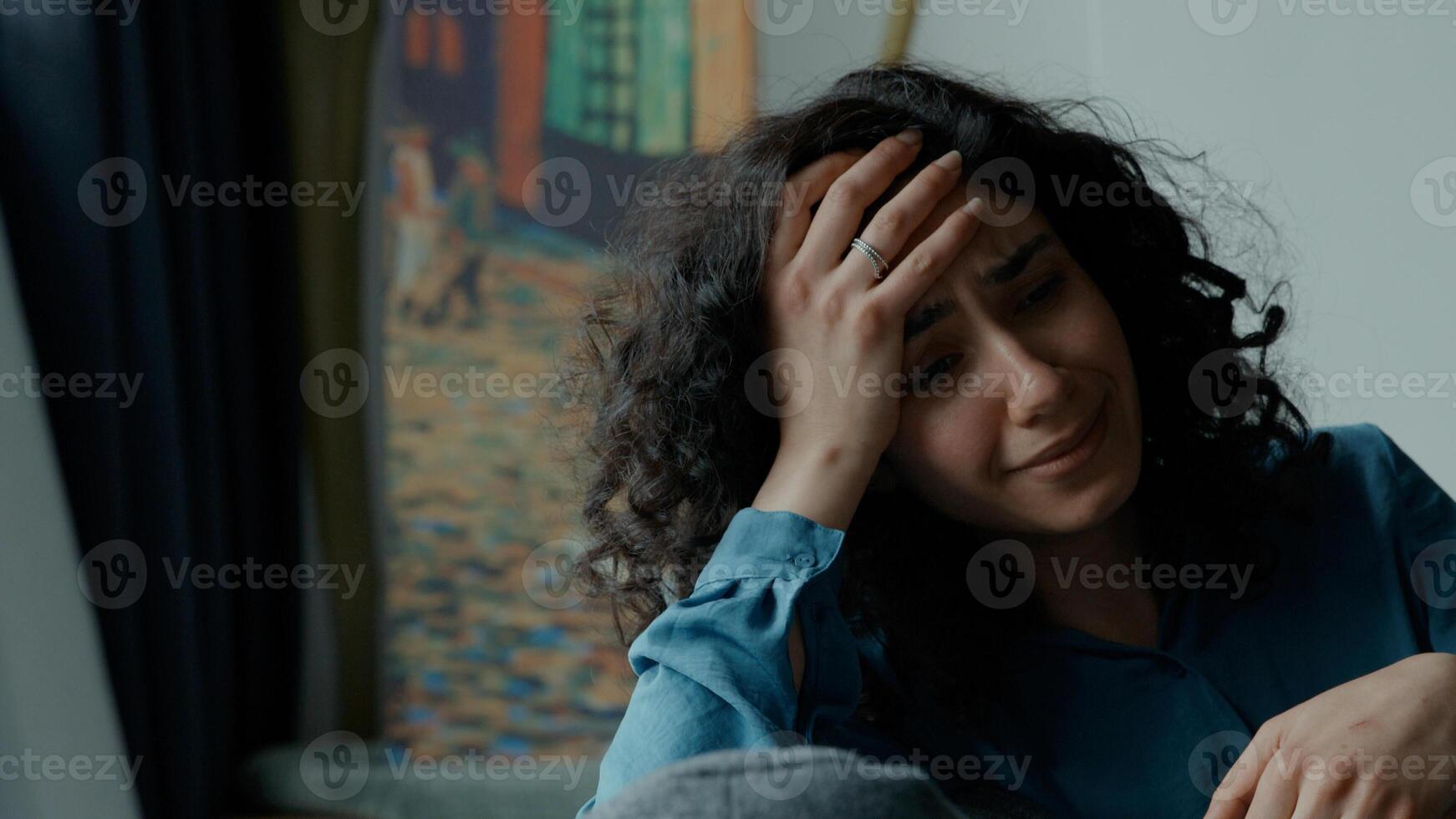 Woman cries on couch photo
