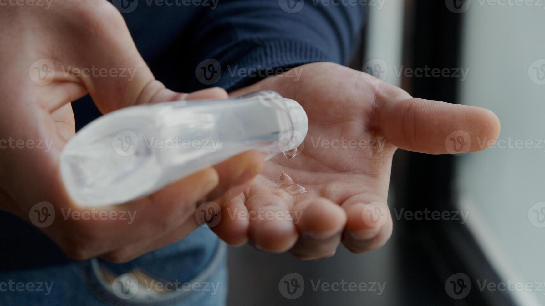 Hands squeeze bottle of hand gel photo