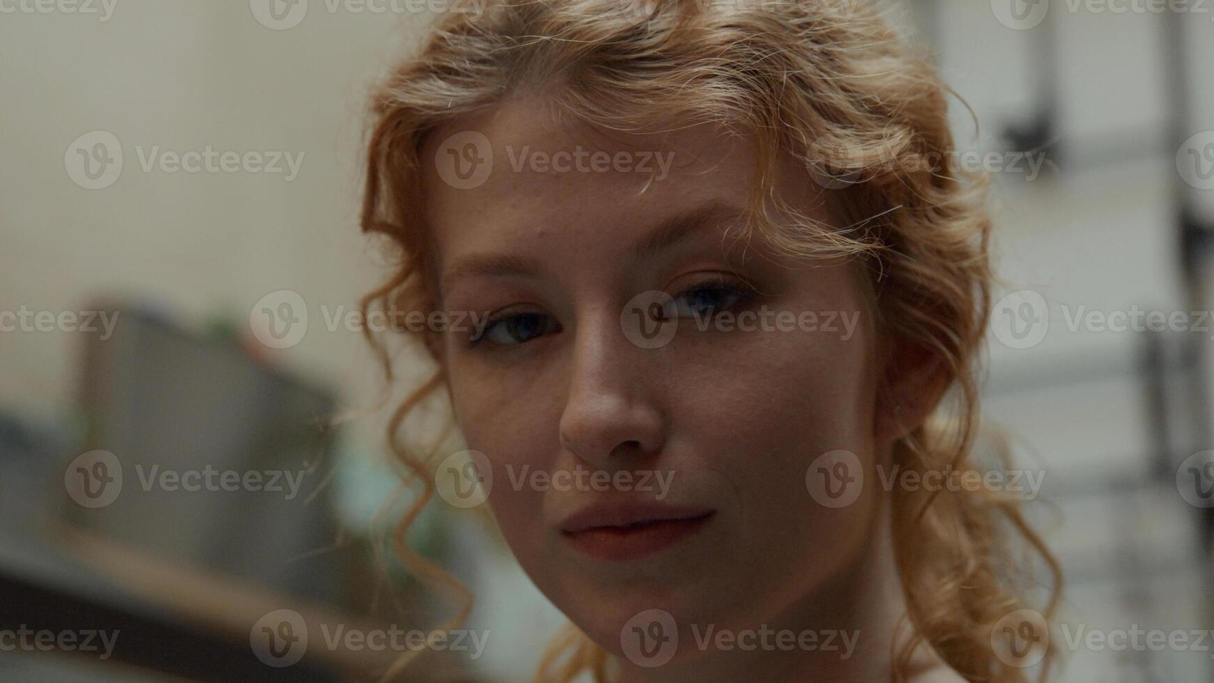 Close up of young white woman, standing in hallway photo