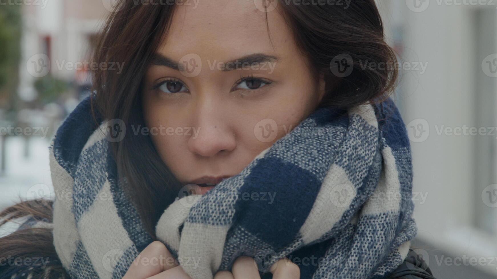 Close up of mixed race woman standing, holding shawl around neck photo