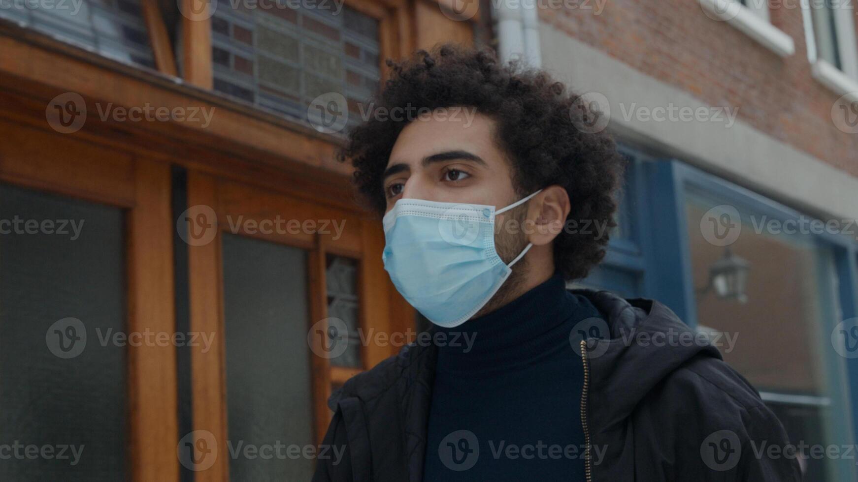 Young Middle Eastern man with face mask on photo