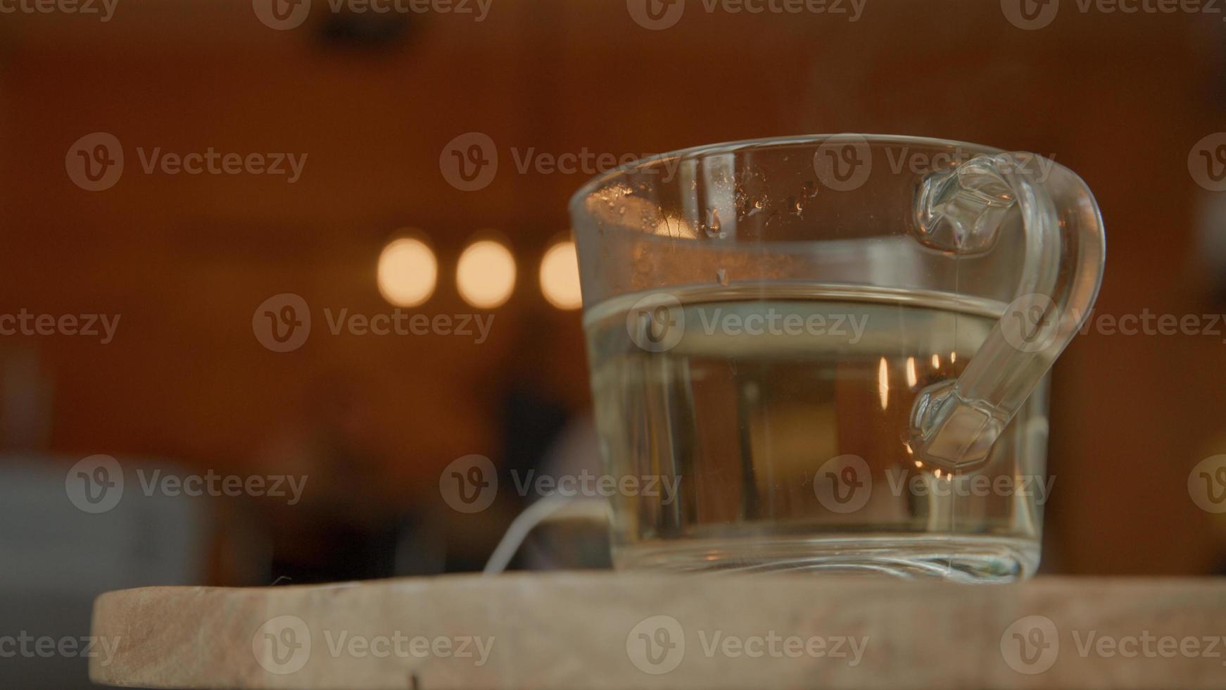 Tea glass with hot water photo