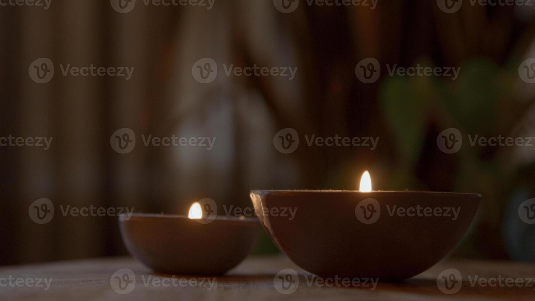 Two burning candles on table photo