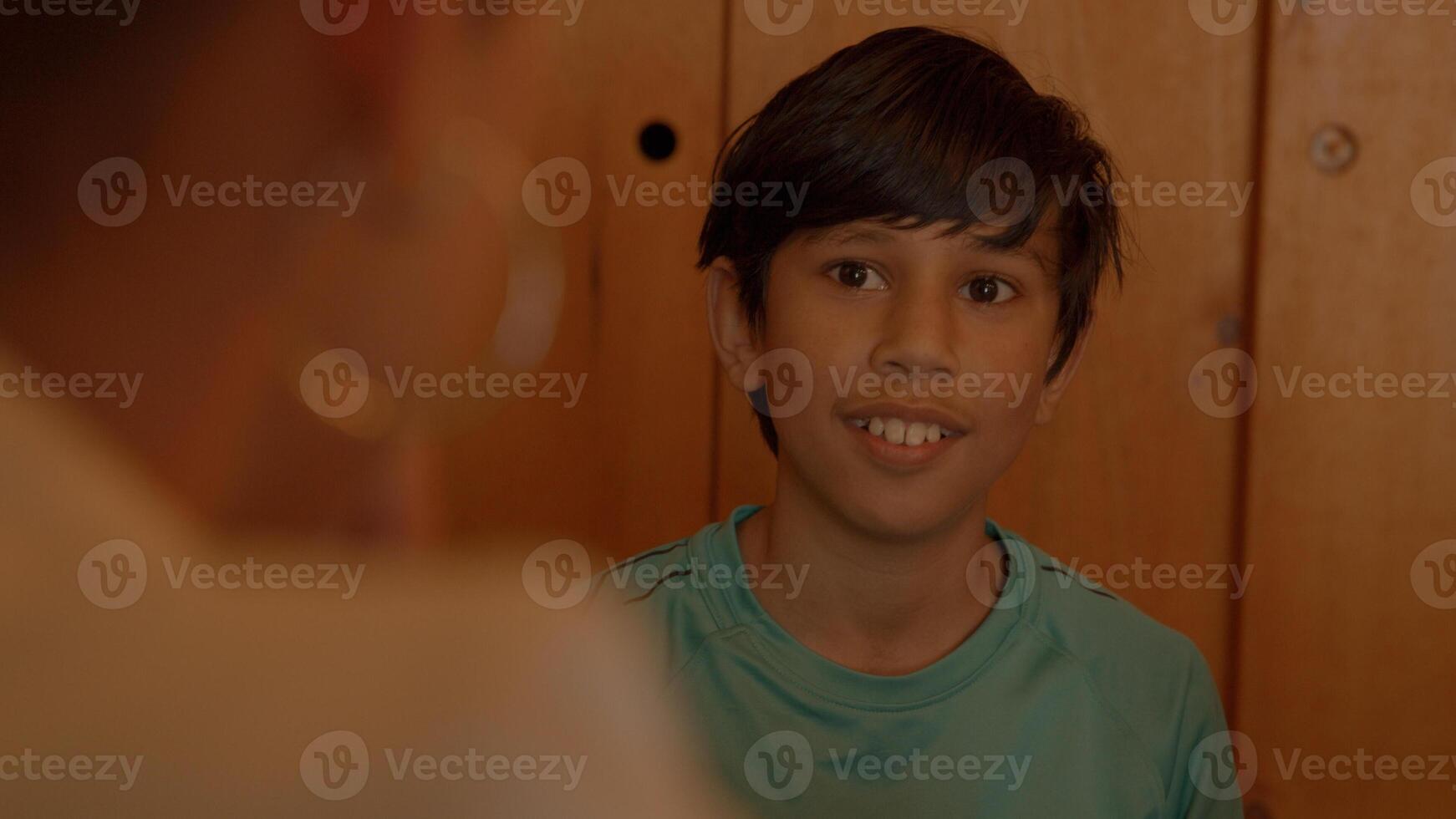 Boy talking with woman at table photo