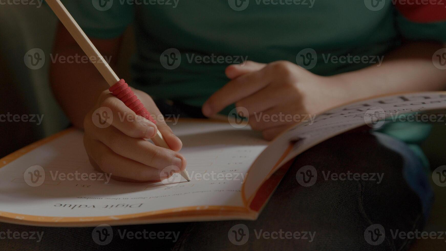 Boy doing maths in armchair photo