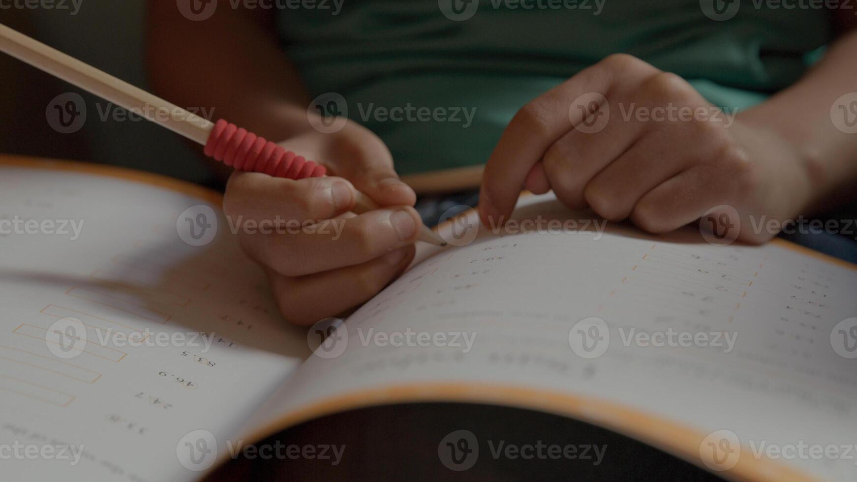 Boy doing maths in armchair photo