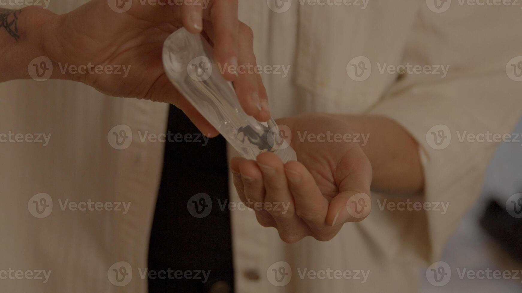 Woman putting hand gel in palm photo