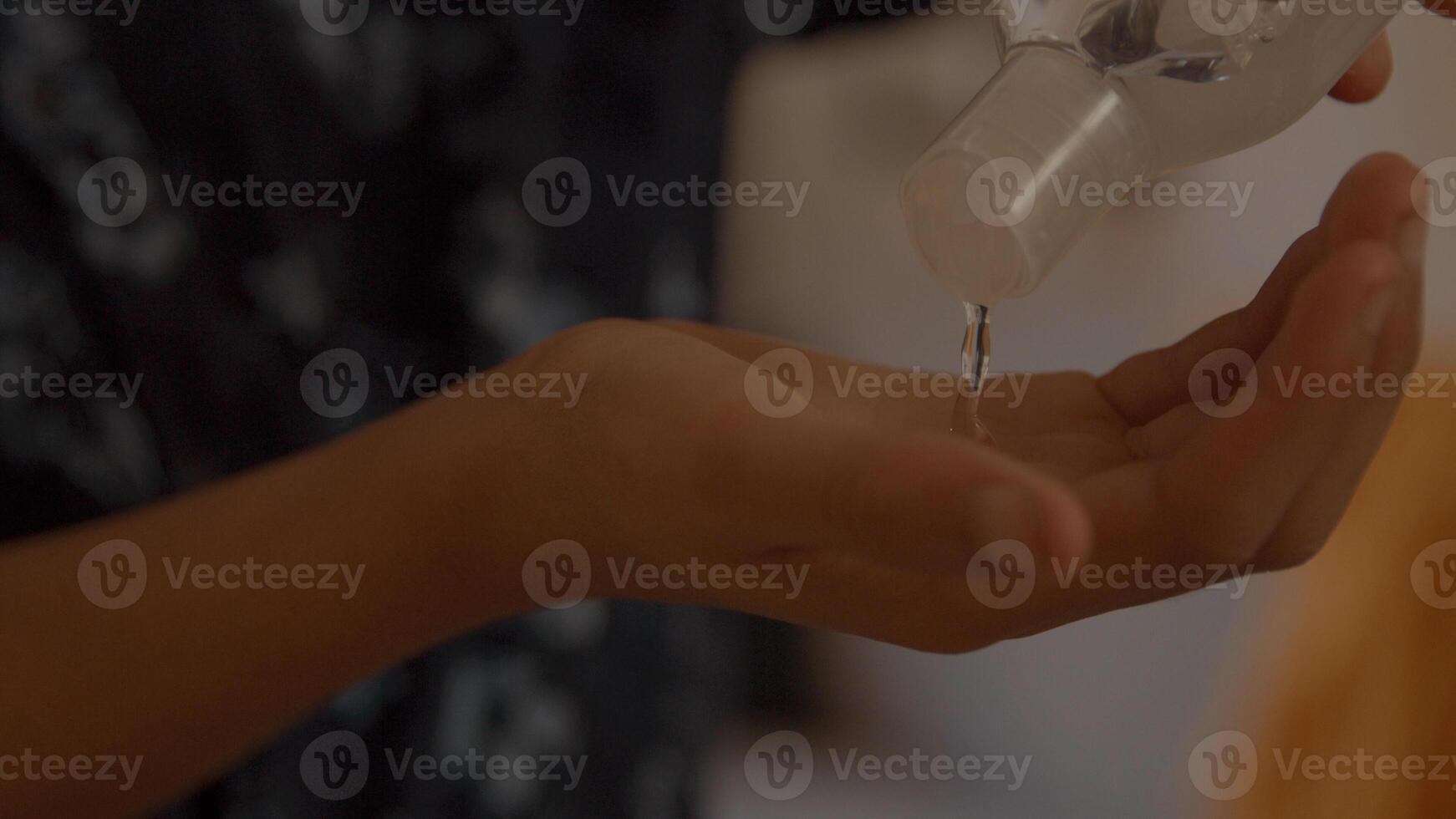 Boy putting hand gel in palm photo