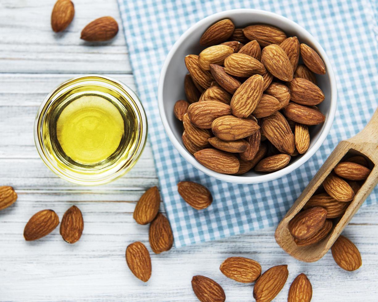 Almond oil and bowl of almonds photo