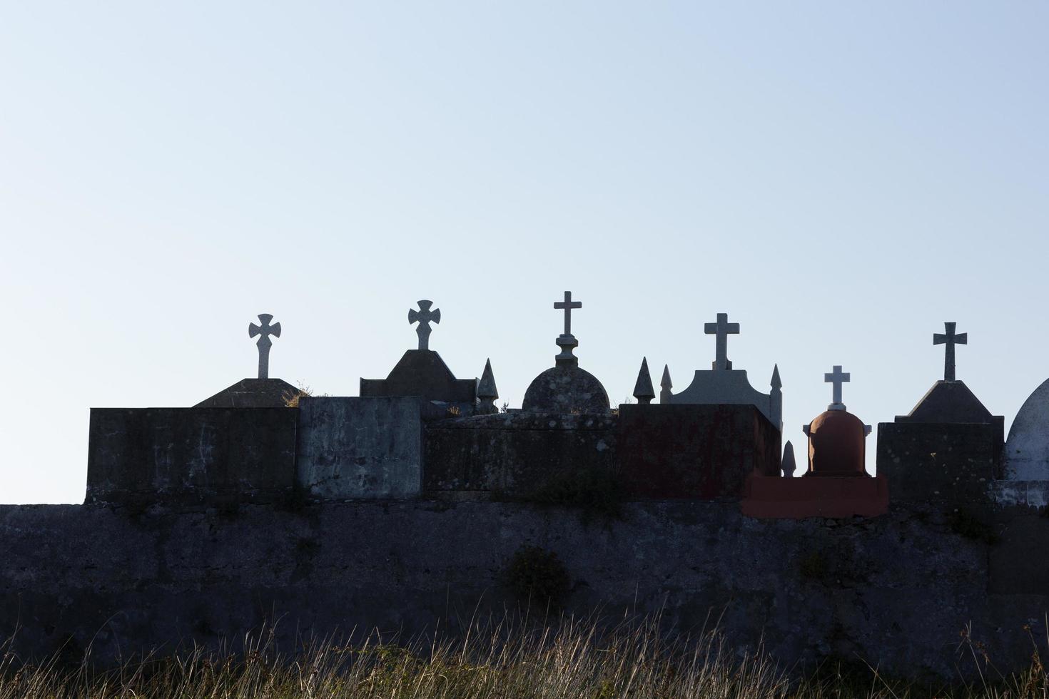 Silhouettes of crosses in a cemetery in Galicia, Spain. photo