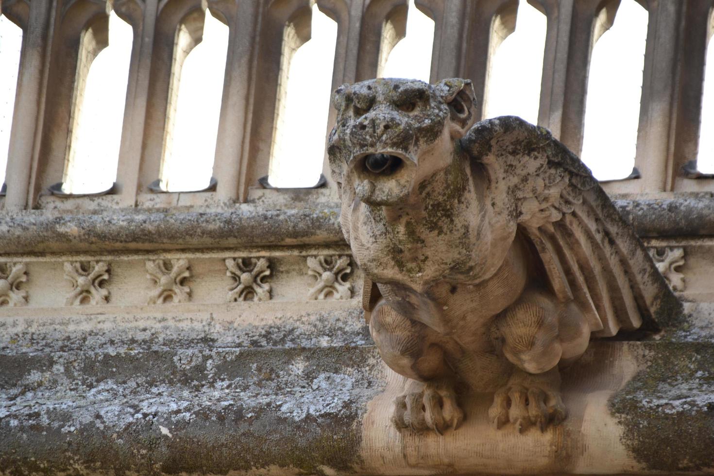 Gargoyle shaped like a monster made of stone photo