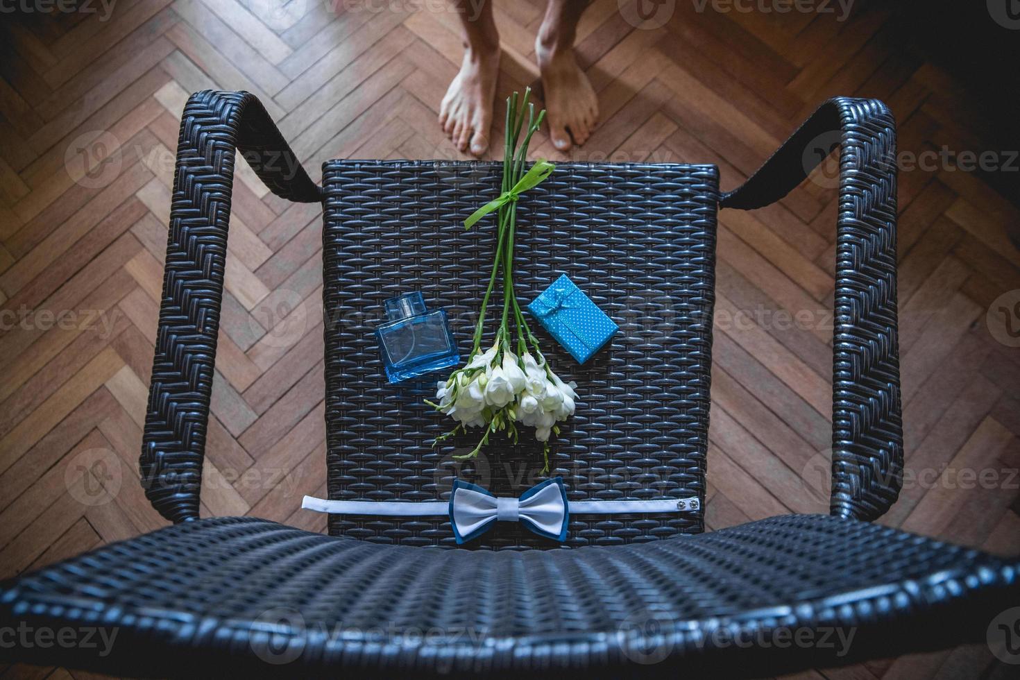 ramo de boda, pañuelo de mariposa y caja de regalo en la silla foto