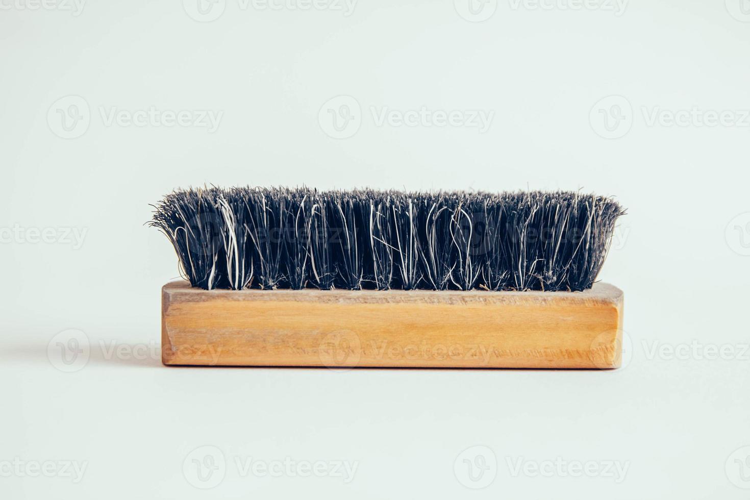 Wooden brush for clothes on a white background photo