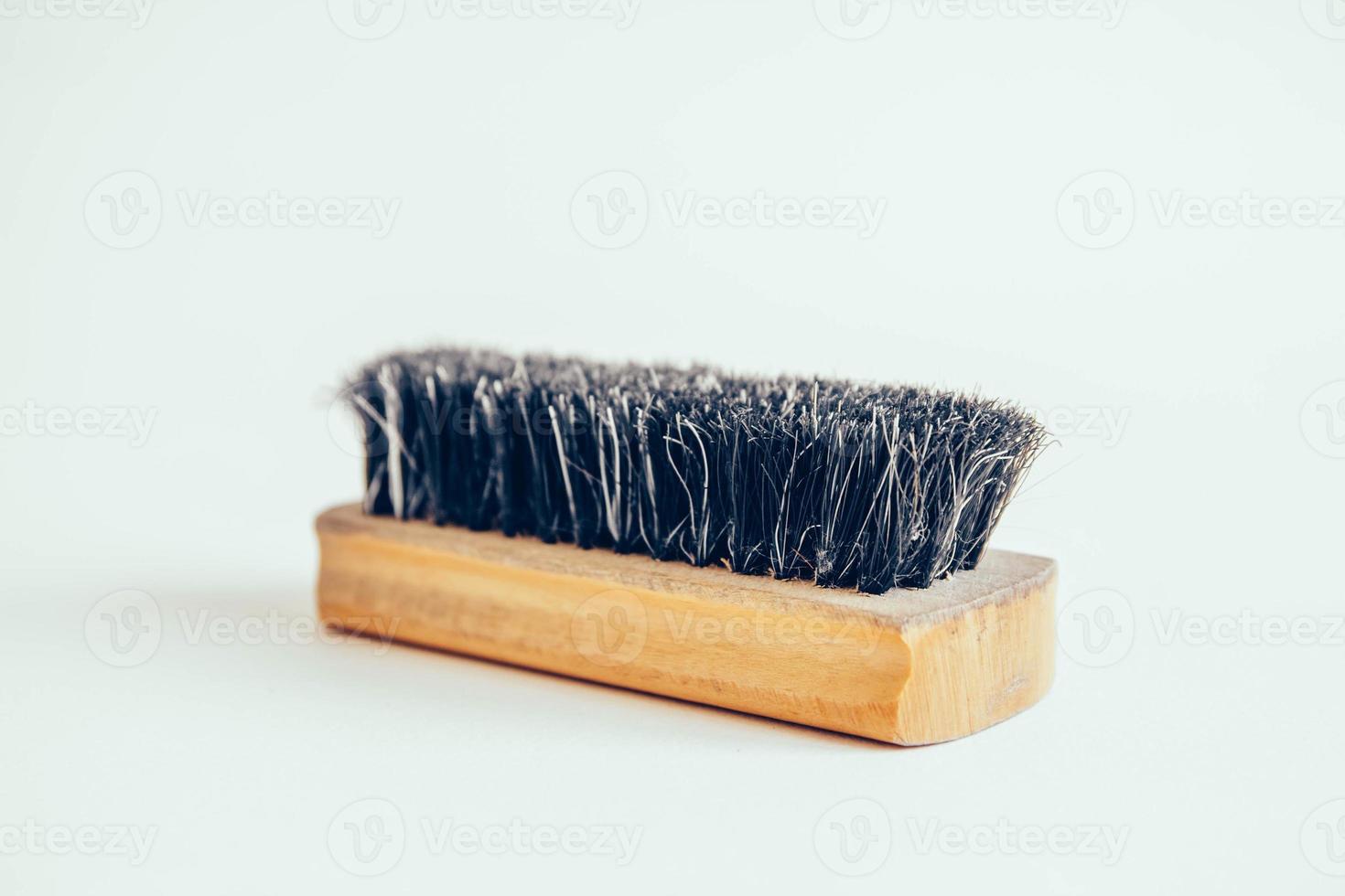 Wooden brush for clothes on a white background photo