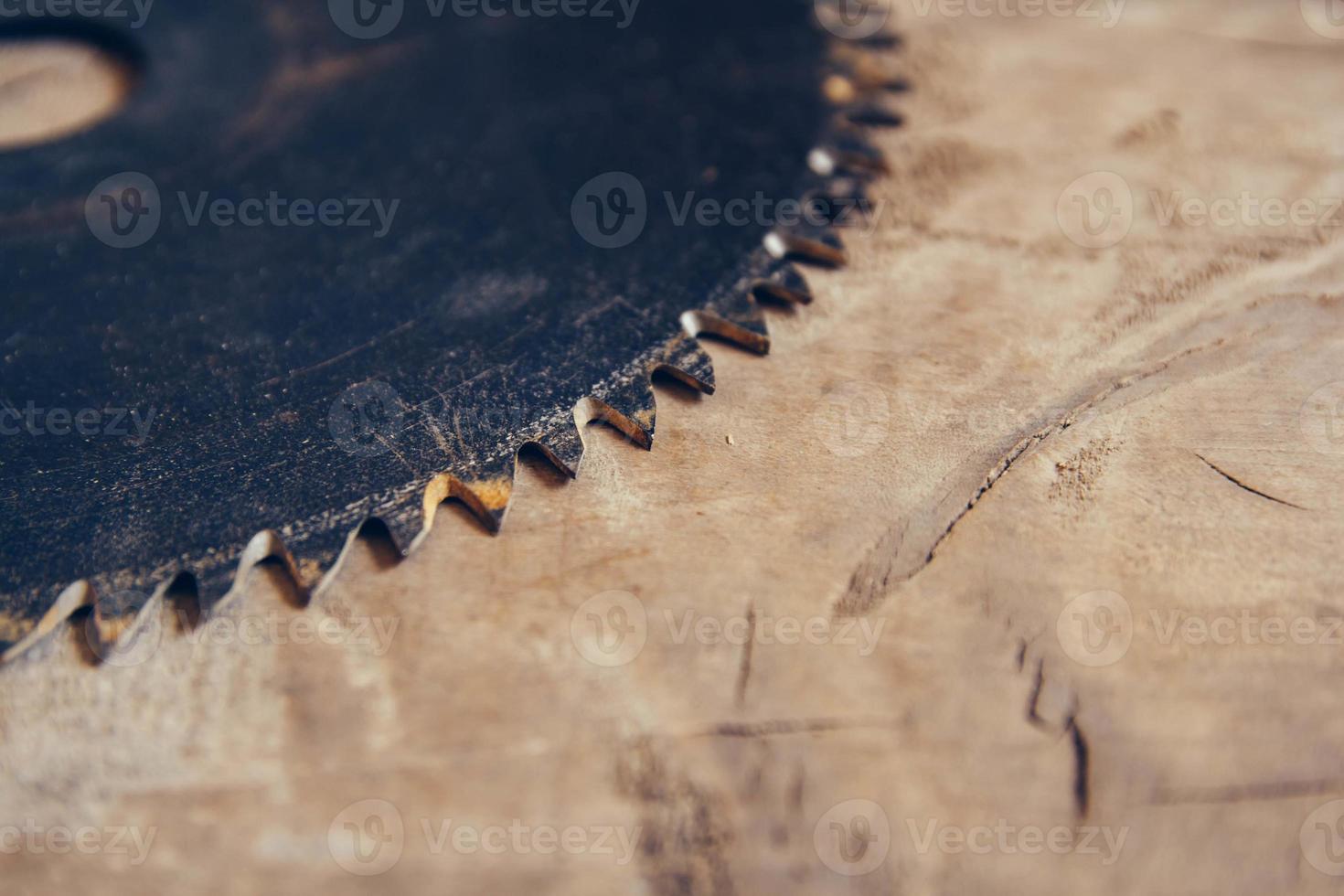 blade circular saw on the background of the wooden table photo