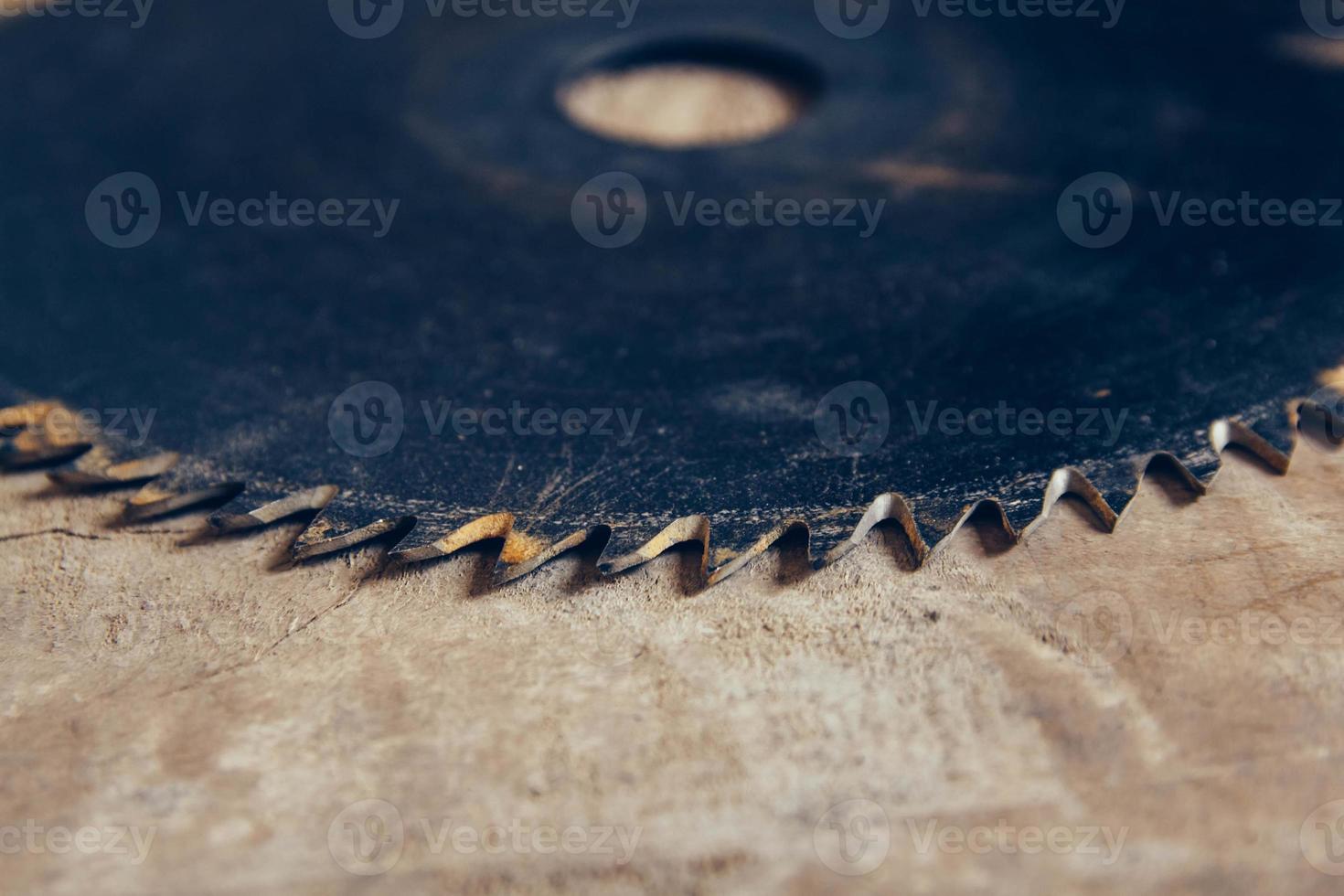 Round blade circular saw on the background of the wooden table photo