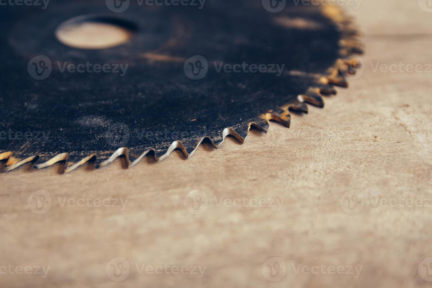 Round blade circular saw on the background of the wooden table photo