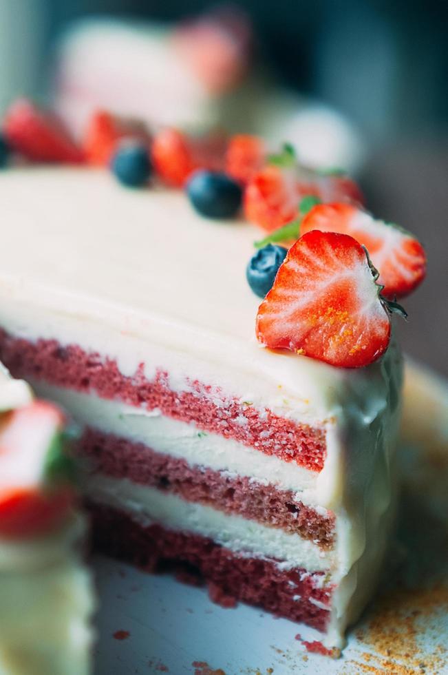 Selective macro focus cake with berries and white glaze photo