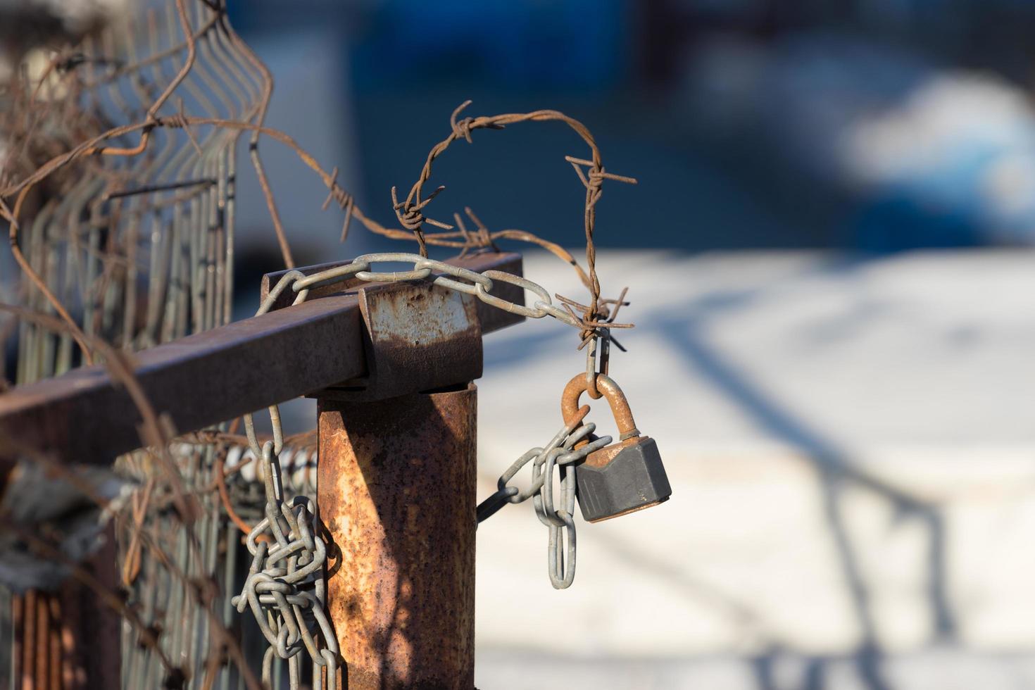 Blurred background with rusty metal wire and lock photo