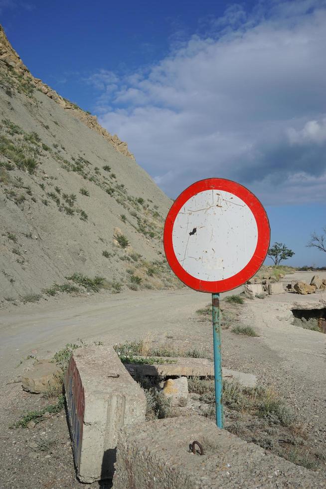 A road sign on the background of the old dilapidated photo