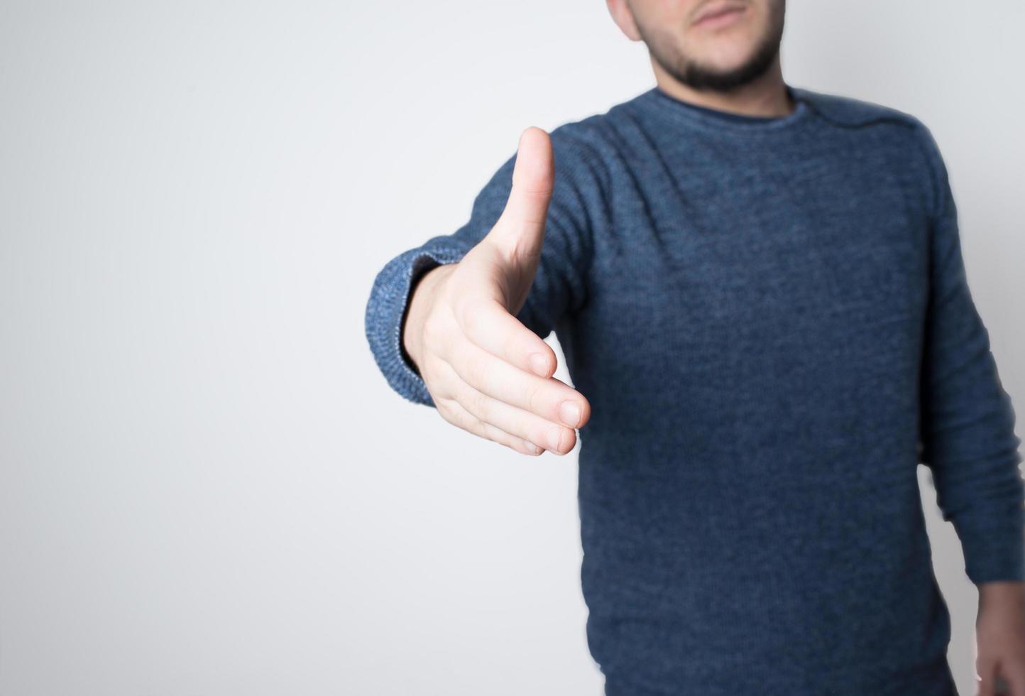 Young man offering his hand to shake photo