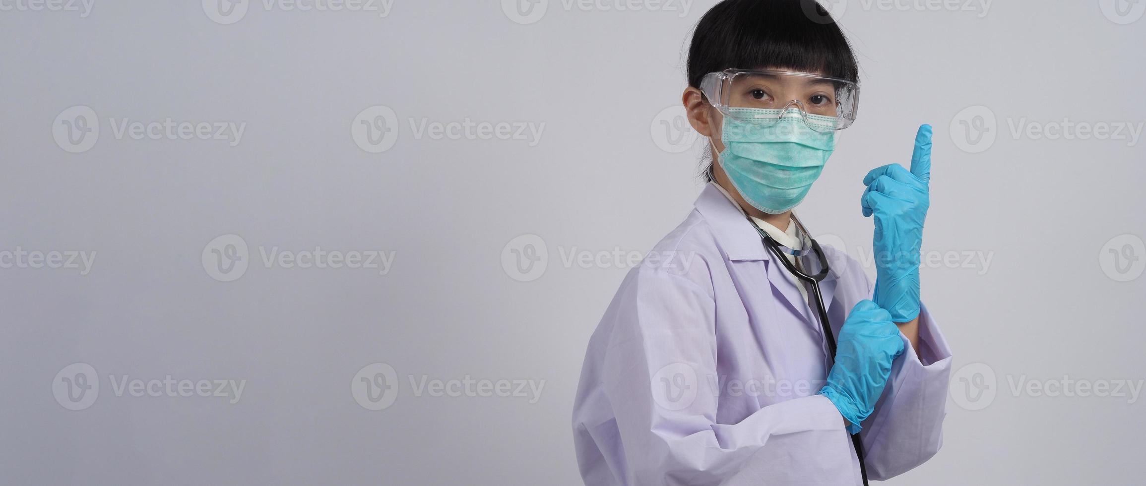 Wearing gloves. Asian doctor wear blue rubber nitrile hands glove. photo