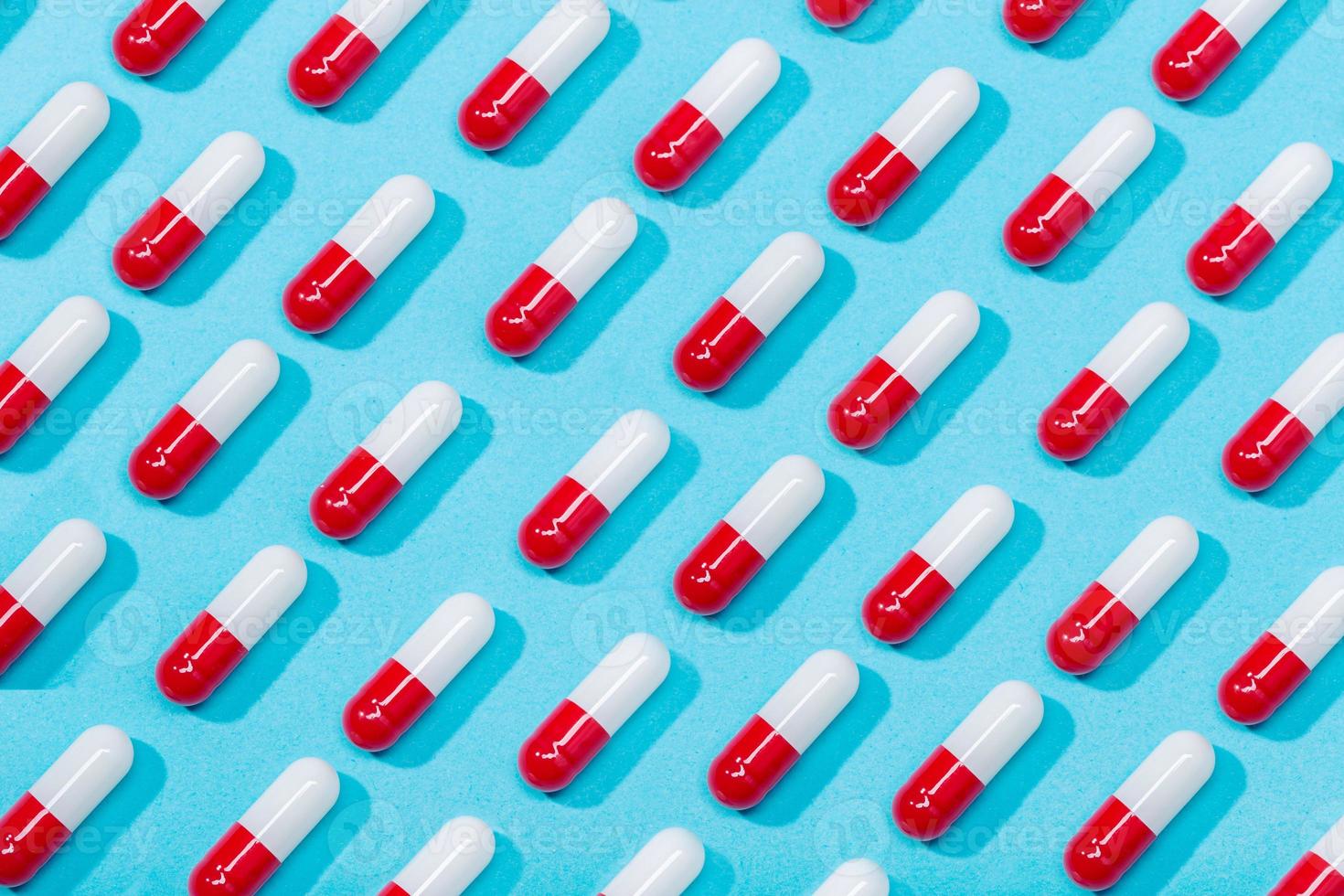 Medical pill capsule isolated on blue background photo