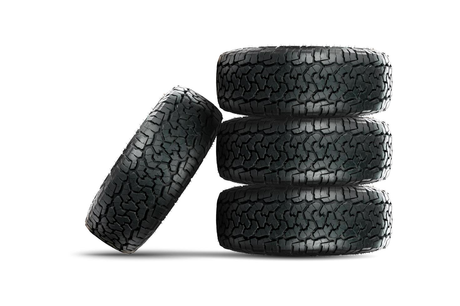 Stack of car tires with alloy wheel isolated on white background photo
