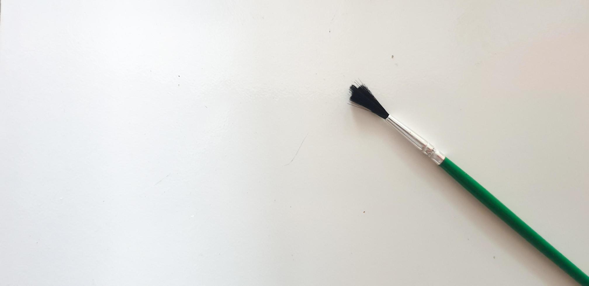 Paint brush on the white ceramic floor photo