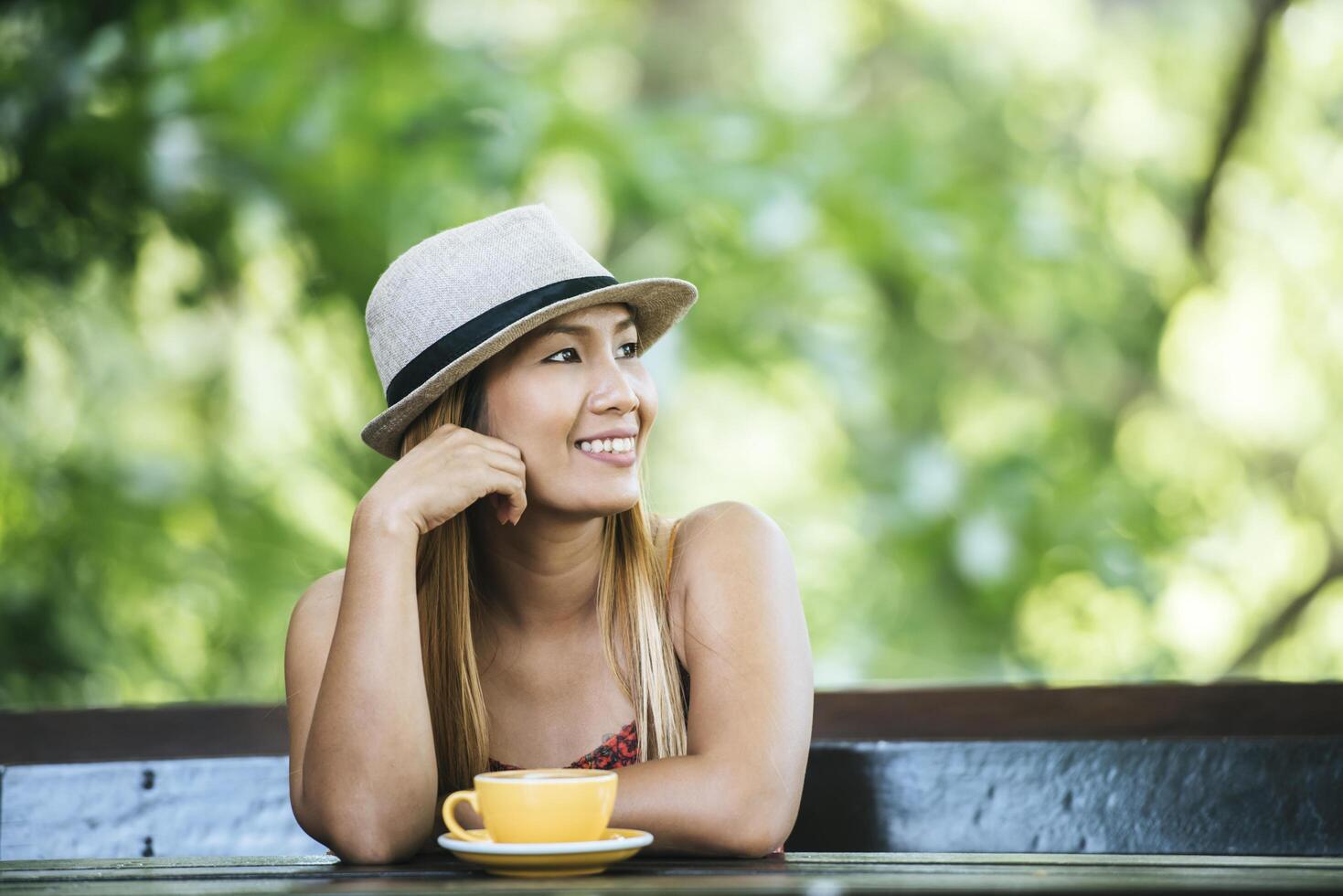 Happy young woman with latte coffee in morning photo