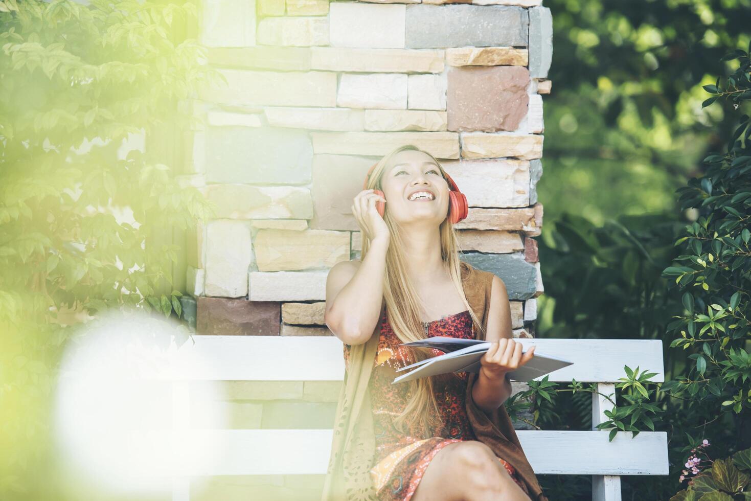 Happy young woman relax with listen favorite music at cafe photo