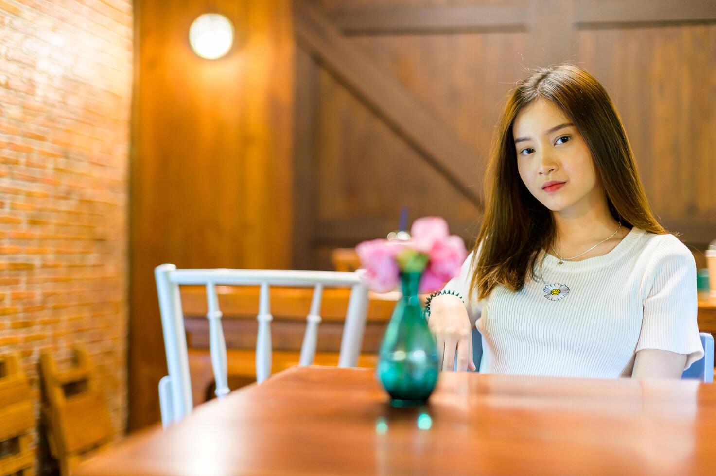 beautiful woman sitting in a chair in a cafe photo