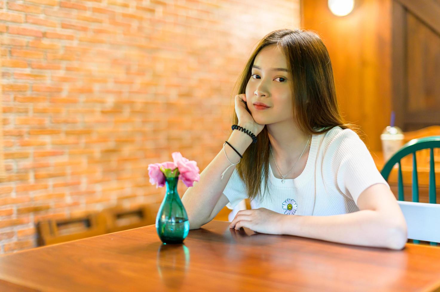 beautiful woman sitting in a chair in a cafe photo