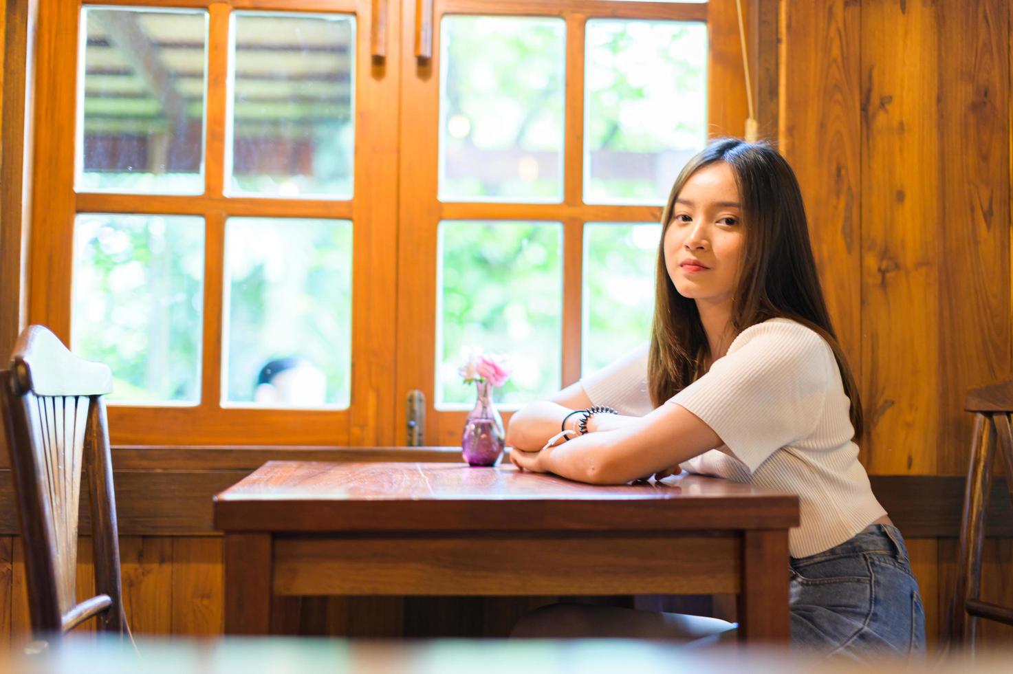 Bella mujer sentada en una silla en un café foto