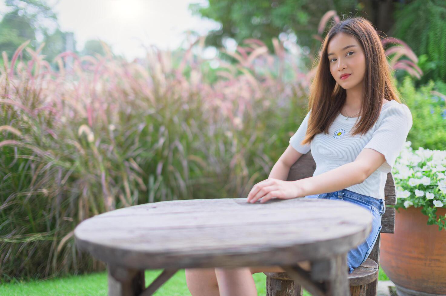 Beautiful women seats in the park photo