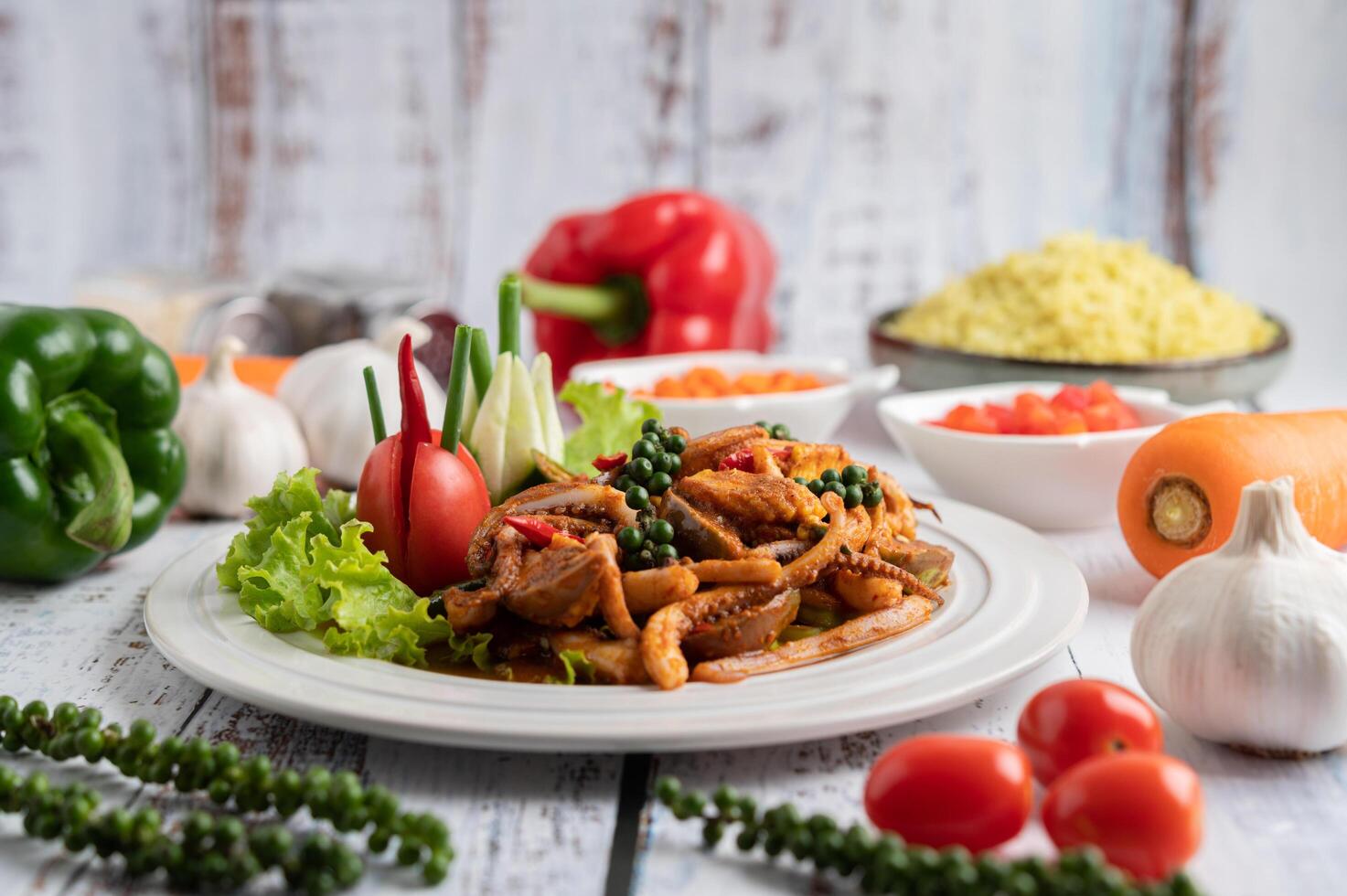 Stir-fried squid with curry paste in white plate. photo