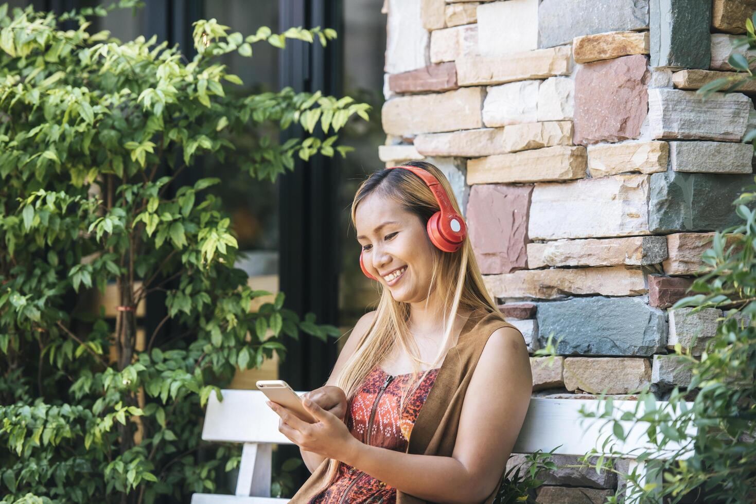 Happy young woman relax with listen favorite music at cafe photo