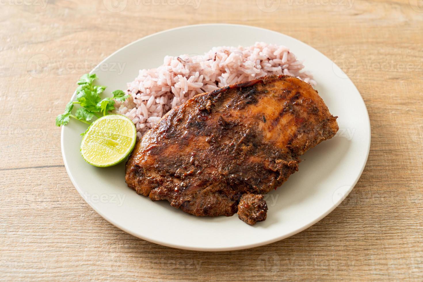 spicy grilled Jamaican jerk chicken with rice photo