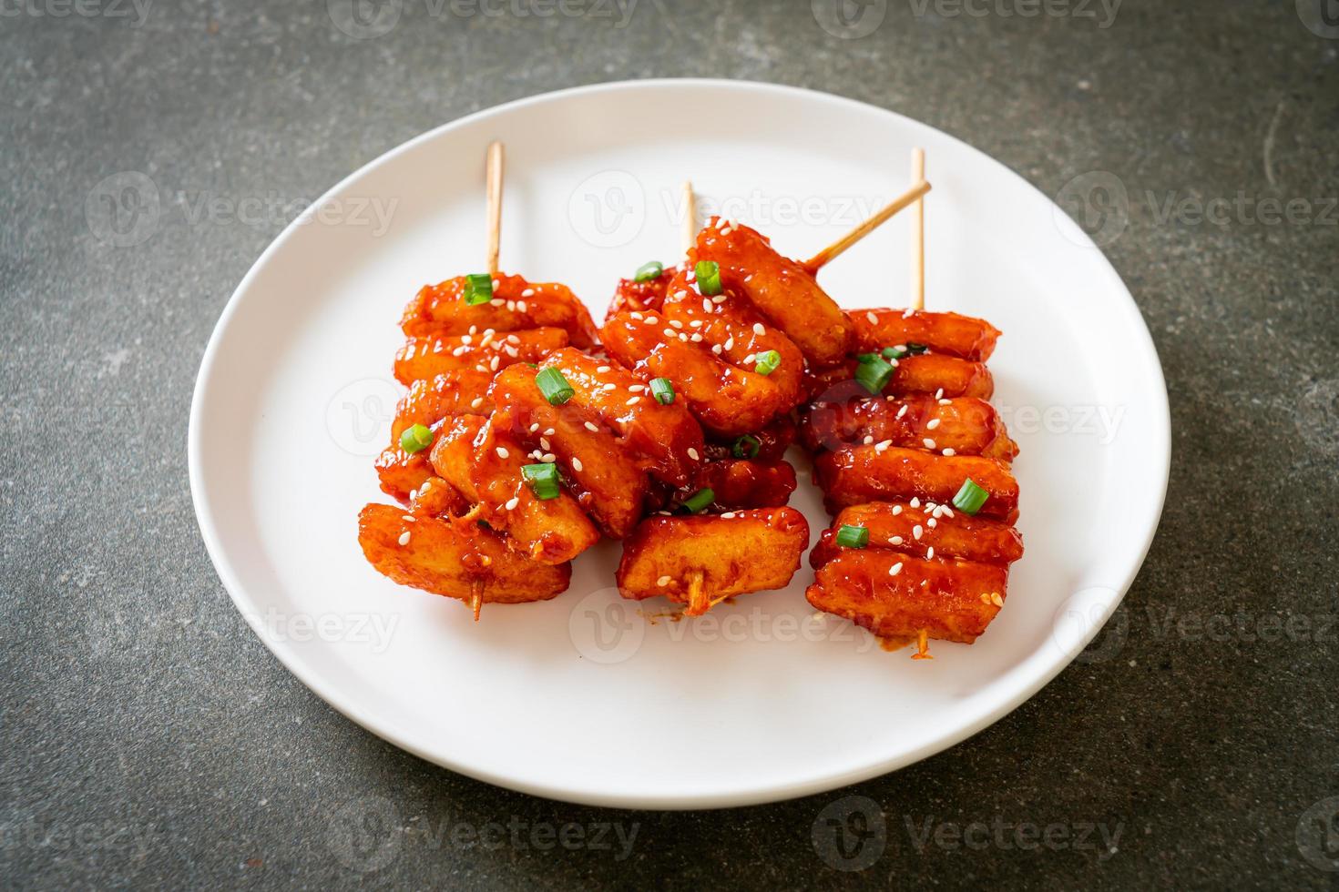 deep fried Korean rice cake skewered with spicy sauce photo