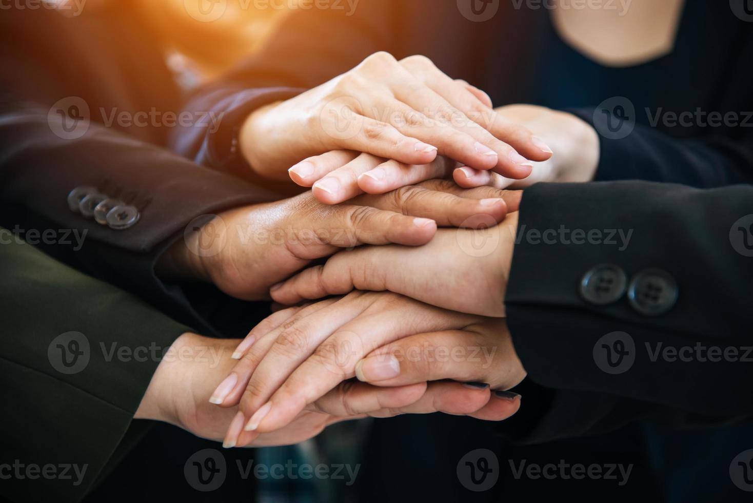 Business people making pile of hands for startup new project photo