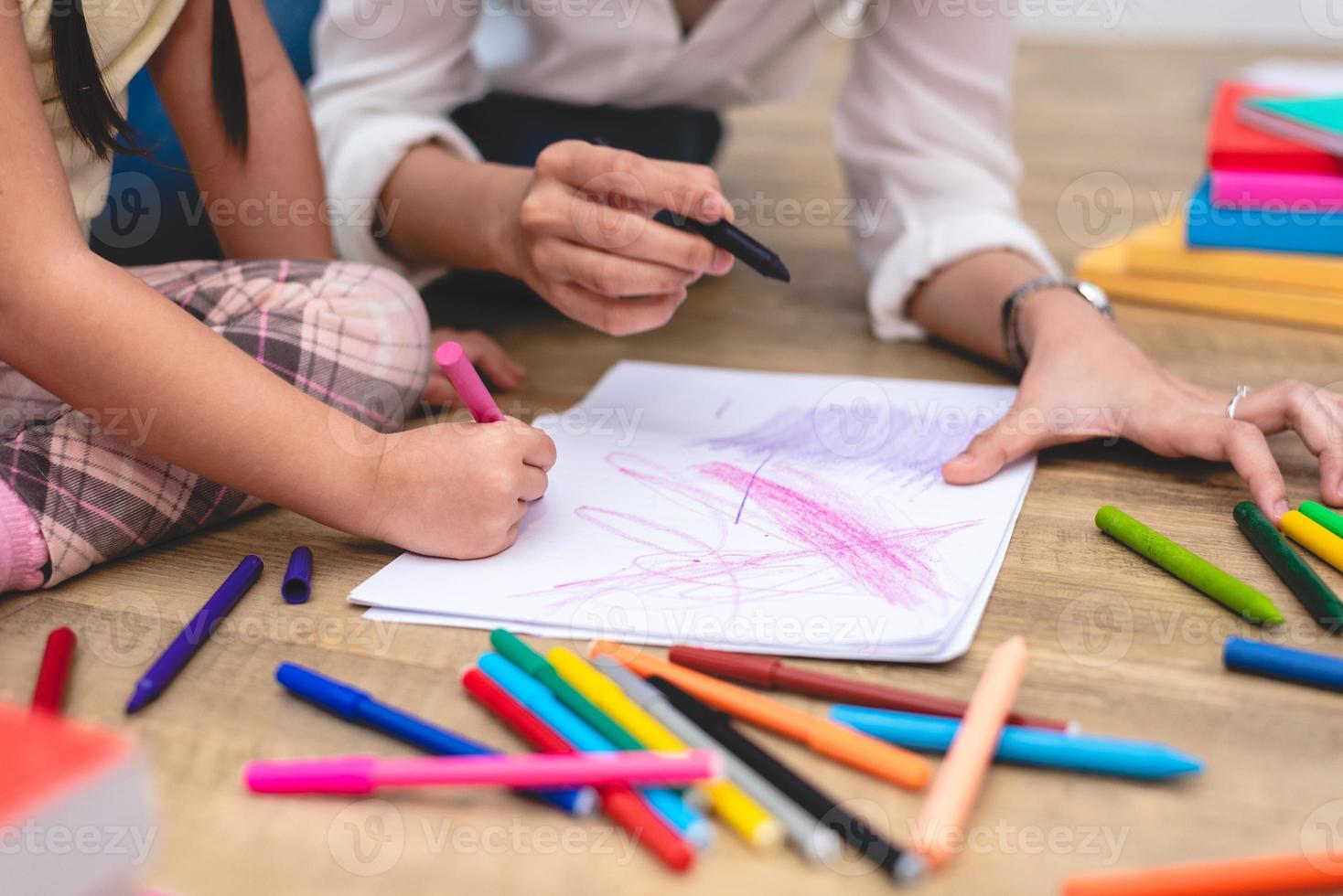 Closed up hands of mom teaching little children drawing photo