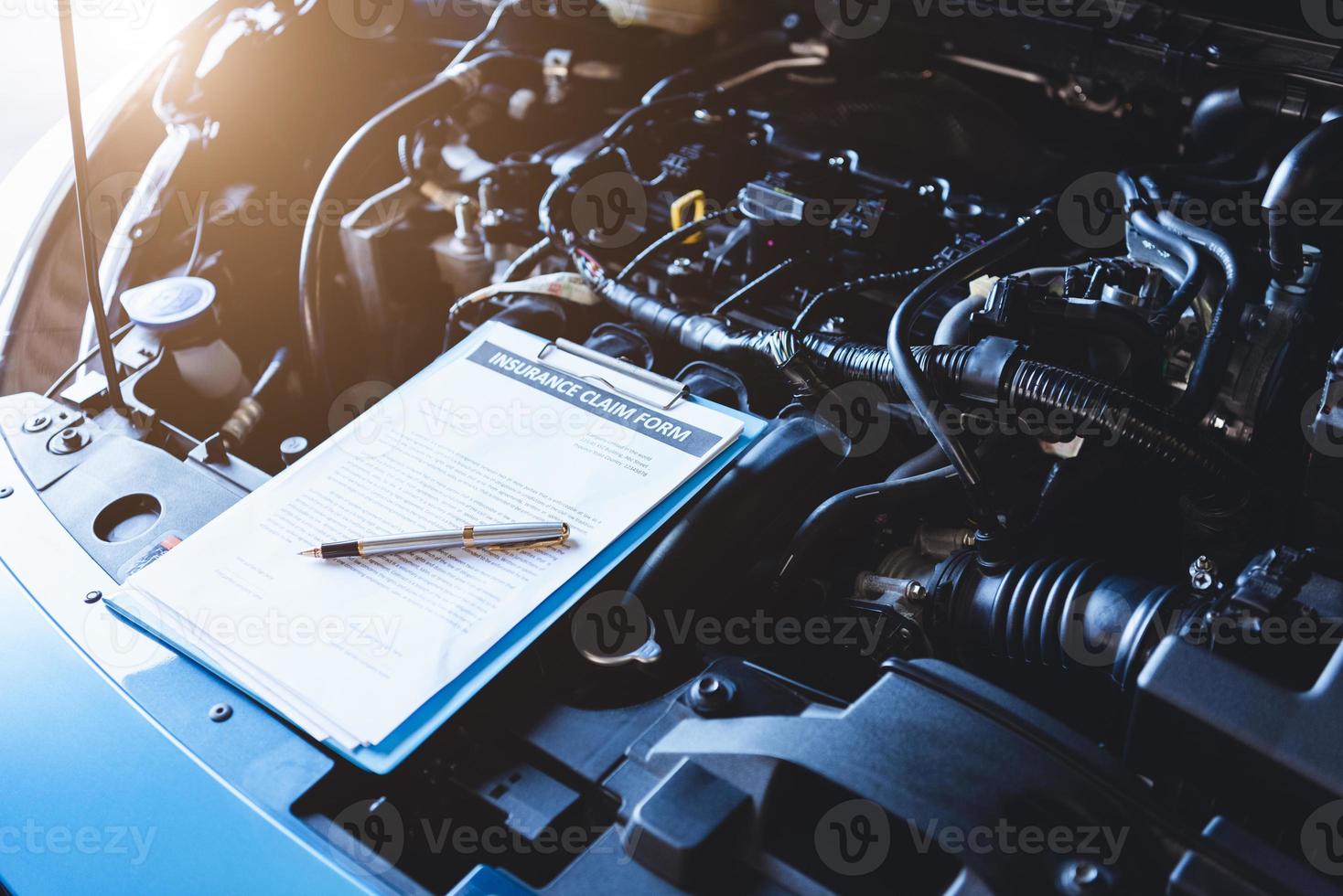 Clipboard on car with car insurance claim form customer maintenance photo