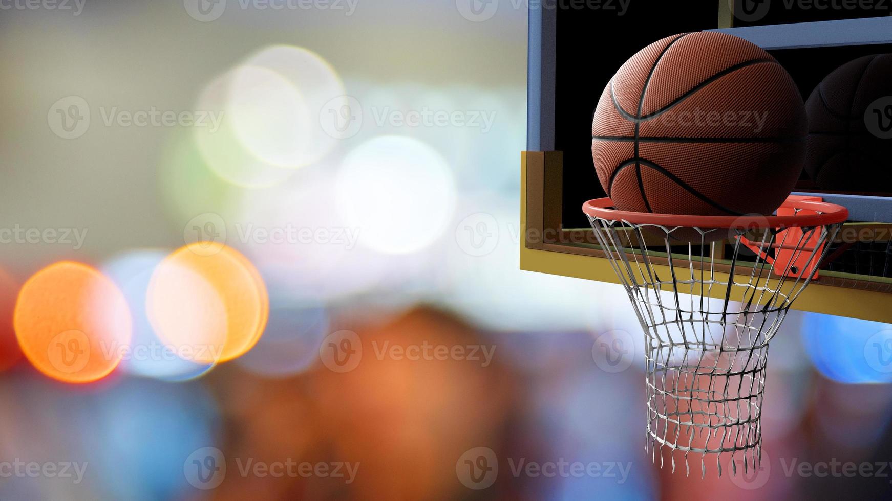 Basketball going into hoop on beautiful bokeh of colorful stadium photo