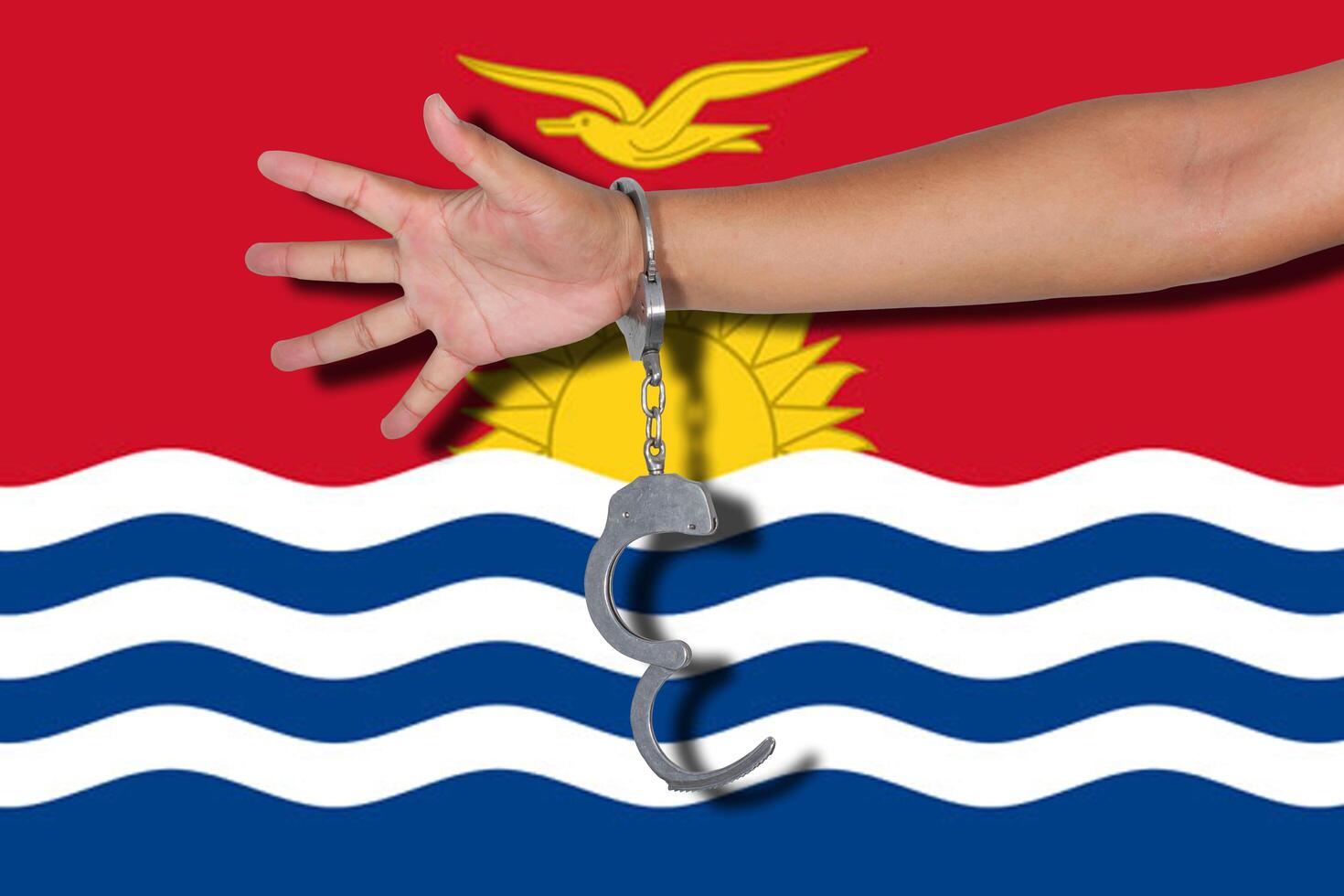 handcuffs with hand on flag photo